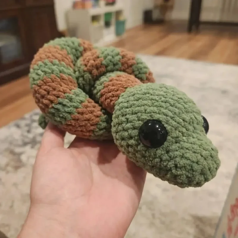 Crochet snake amigurumi with coral colourwork bands — photo 2