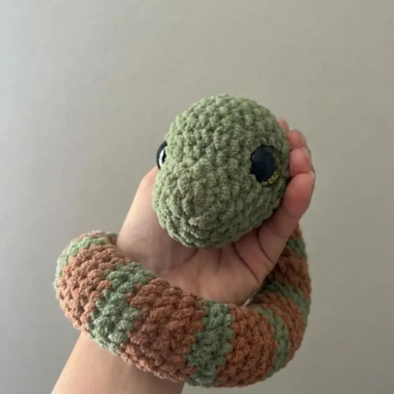 Crochet snake amigurumi with coral colourwork bands — photo 3